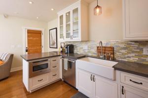 a kitchen with white cabinets and a sink at Playa One Bedroom (253) in Carpinteria