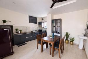 a kitchen with a wooden table and chairs in it at Gayathri Residency premium 2bhk in Hyderabad