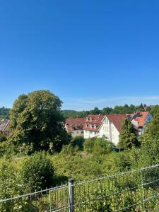 a group of houses on a hill with a fence at Ferienwohnung im Herzen Backnangs - 2 Zimmer in Backnang