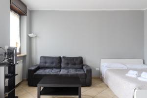 a living room with a couch and a bed at Turin Airport apt G in Leinì