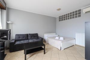 a living room with a couch and a bed at Turin Airport apt G in Leinì
