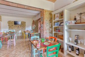 a restaurant with tables and chairs in a room at La Quinta Decima Bioagriturismo in Fattoria Spedaletto
