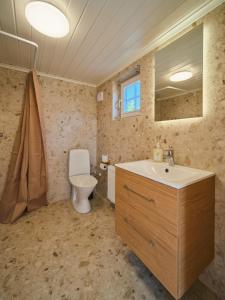a bathroom with a sink and a toilet at Lakeside Herrestad in Värnamo +14 photos