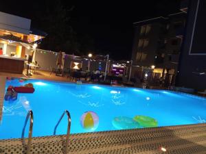 a large swimming pool at night at Logements Majeo in Kribi +15 photos