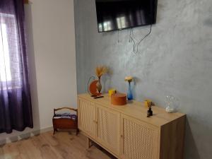 a wooden cabinet with vases on it in a room at Luca`s Chalet Ocnele Mari in Ocnele Mari