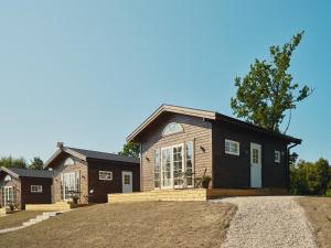 a large house with a large driveway in front of it at Lakeside Herrestad in Värnamo