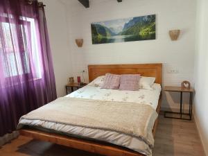 a bedroom with a bed with two pillows on it at Luca`s Chalet Ocnele Mari in Ocnele Mari