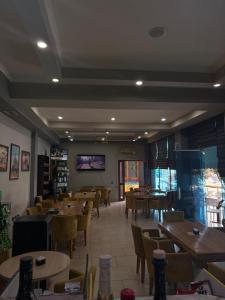 a dining room with tables and chairs and a room with tables at Hotel Bar Restaurant Riviera in Shëngjin