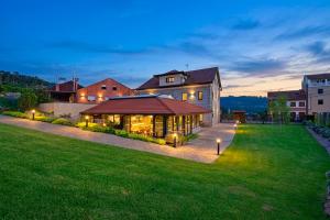 a large house with a green yard with lights at Pardavila 57 Slow Hotel in Marín