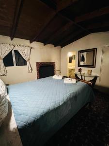 a bedroom with a large blue bed in a room at Rancho Meling in Camalú