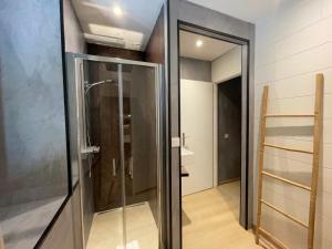 a walk in shower in a bathroom with a glass door at La chaumette in Pannessières +8 photos
