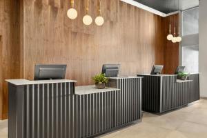 a lobby with three desks with computers on them at Sheraton Tribeca New York Hotel in New York