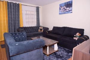 a living room with two couches and a coffee table at Micasa Homes BNB D2 in Limuru
