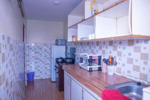 a kitchen with a sink and a counter top at Micasa Homes BNB D2 in Limuru