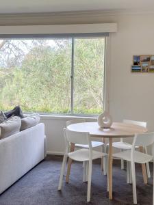 a table and chairs in a room with a window at Cozy & Spacious Family Unit Mt Martha in Mount Martha