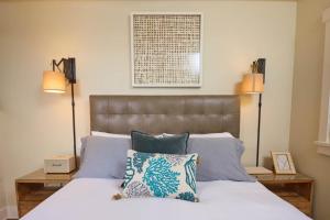 a bedroom with a bed with pillows and two lamps at Playa One Bedroom (255) in Carpinteria