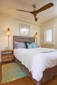 a bedroom with a large bed with a ceiling fan at Playa One Bedroom (255) in Carpinteria
