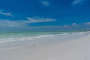 a beach with the ocean and a blue sky at Lovers Key #508 by Sun Palace Vacations in Fort Myers Beach
