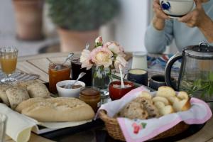 a table topped with a tray of bread and flowers at Chambre d'hotes la Mainguy in Ruca +10 photos