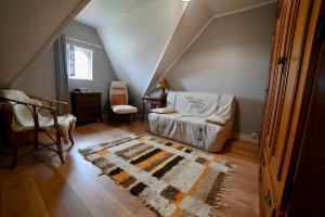 a living room with a couch and a rug at Chambre d'hotes la Mainguy in Ruca