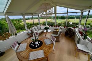 a large living room with a table and chairs at Chambre d'hotes la Mainguy in Ruca