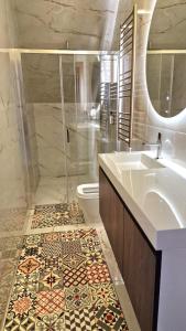 a bathroom with a sink and a toilet and a mirror at Cidadela do Viriato in Viseu