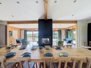 a living room with a wooden table and a fireplace at Le Refuge du Trappeur in Hour +19 photos