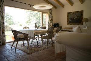a dining room with a table and chairs at Finca El Ropero Eco-friendly house in Villanueva de la Vera