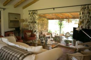a living room with a couch and a table at Finca El Ropero Eco-friendly house in Villanueva de la Vera
