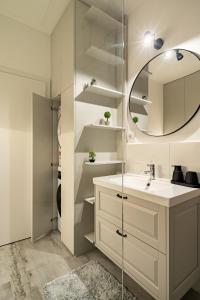 a bathroom with a sink and a mirror at A&R Residence Nest in Arad +39 photos