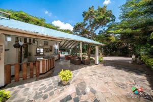 an outdoor patio with a kitchen and a building at Tan-Swiss Lodge in Mikumi