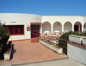 a large white building with a red door at Cielo e Mare in Scalea