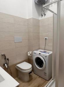 a bathroom with a washing machine and a toilet at Cielo e Mare in Scalea +62 photos