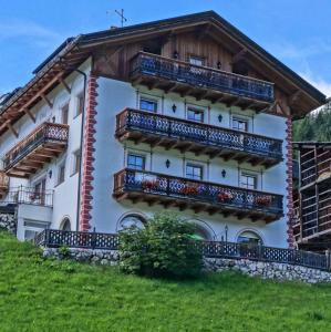 a building with balconies on the side of it at Tinahof in Selva di Val Gardena