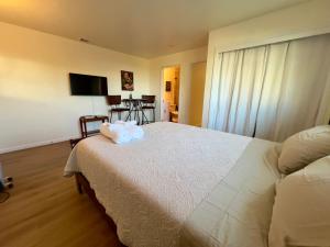 a bedroom with a bed with a stuffed animal on it at Charming studio one mile from beach in Aptos