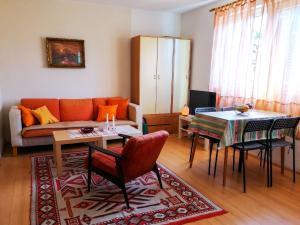 a living room with a couch and a table at Villa Lila in Dolno Dupeni
