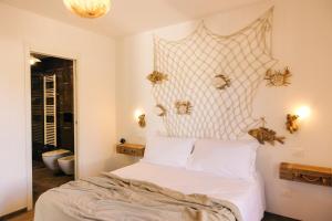 a bedroom with a bed with a netted headboard at Appartamento Sea - Tenuta Fascianello in Fasano