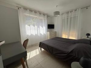 a bedroom with a bed and a desk and a window at Casa Mezzana in Valle-di-Mezzana