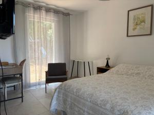 a bedroom with a bed and a desk and a window at Casa Mezzana in Valle-di-Mezzana +1 photo
