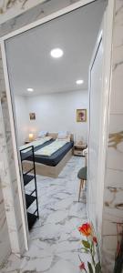 a bedroom with a bed and a desk in a room at Тера Лакшъри Суит in Asenovgrad