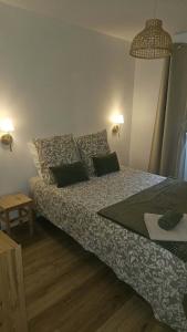 a bedroom with a bed and a table and lights at Holy Cottage in Sainpuits +11 photos