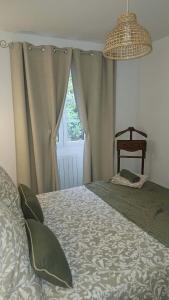 a bedroom with a bed and a window at Holy Cottage in Sainpuits