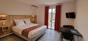 a hotel room with a bed and a balcony at Le Moulin du Verdon in Gréoux-les-Bains