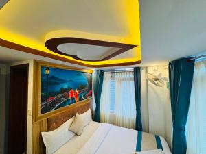 a bedroom with a bed with a yellow ceiling at Hotel Delite in Thapathali +1 photo