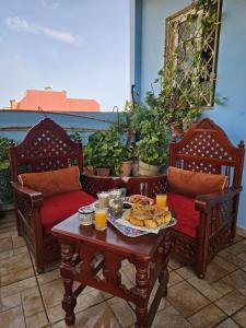 a table with a tray of food on a patio at Pearl studio avec terrasse in Larache