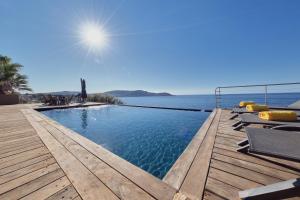 a swimming pool with a view of the ocean at Cala Di Mare Villa in Calvi