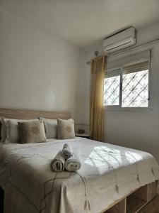 a bedroom with a large bed with towels on it at Pearl studio avec terrasse in Larache