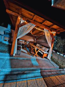 a chair sitting under a table with lights on it at Vila Ejna , Misevici in Rakovica