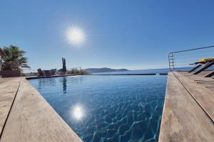 a swimming pool with a view of the water at Cala Di Mare Villa in Calvi