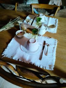 a table with a table cloth with a tea set on it at Le Logis Rabelaisien in Bourgueil